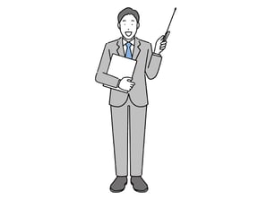 何かを指している男性