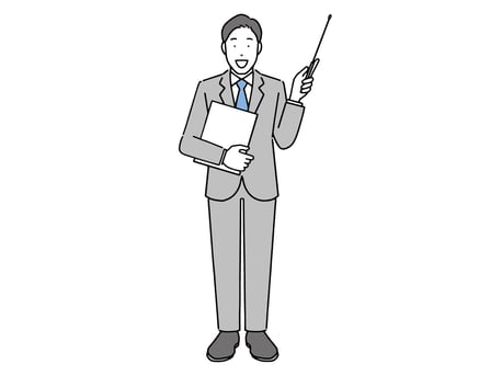 何かを指している男性