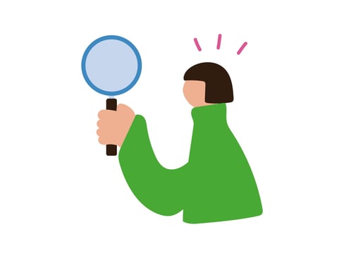 虫眼鏡で何かを見つける人