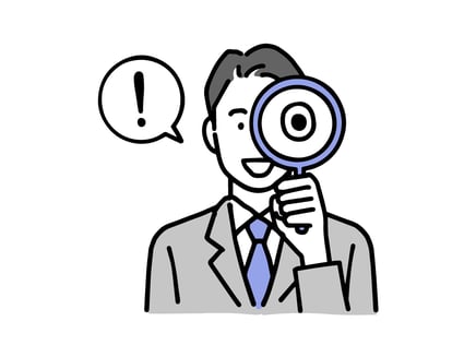 虫眼鏡を覗く男性