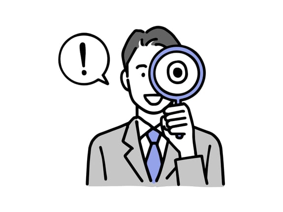 虫眼鏡を覗く男性